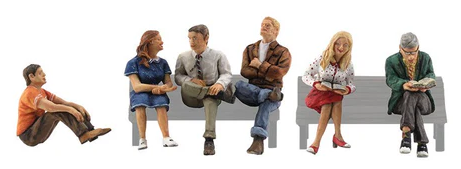 Set of miniature figures sitting on a bench against a white background