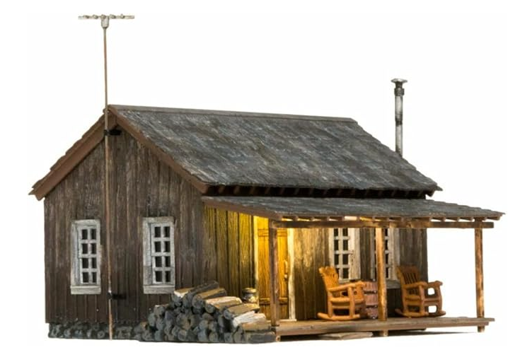 Model of a wooden cabin with a porch on a white background