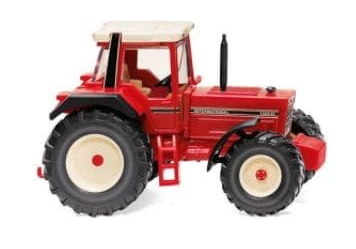 Red toy tractor on a white background