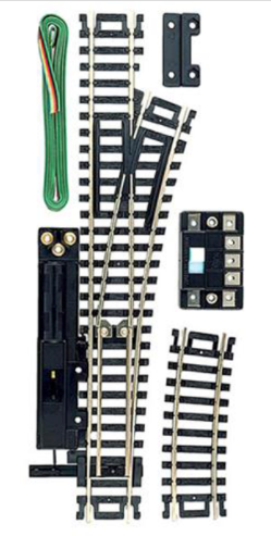 A set of model train track switches with black ties and nickel silver rail, along with a remote control device.