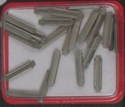 A set of metallic model train rail joiners displayed in a clear plastic case.