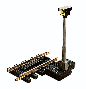 An electric uncoupler for toy trains, featuring a lighted 'E' signal, in black color with a grey base and metallic parts.