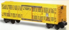 A yellow LIONEL Union Pacific CarSounds stock car with detailed molded body and metal chassis visible.