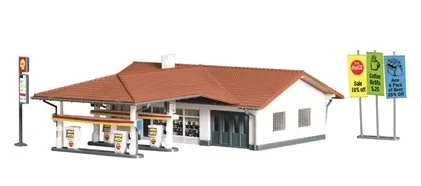 N scale model of a service station with a built-up section featuring signs and LED lighting.