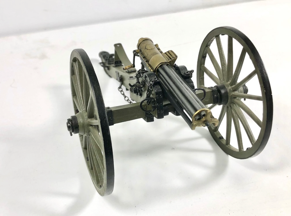 A 1:16 scale model of a Civil War GATLING GUN made with Britannia metal, showing the assembled gun with a green finish and a detailed barrel.