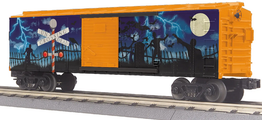 An O gauge model of a box car with blinking LED lights, featuring a colorful Halloween-themed design on the side.