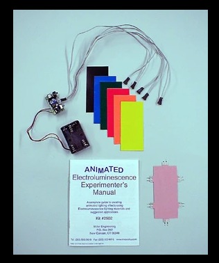 A kit containing an EL (electroluminescence) experimenter's circuit board with various colorful overlays and a pink ready-to-run power supply.