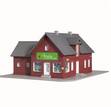 A model of Annie's Country Store and Bakery, featuring a red brick exterior, gray roof, and a sign on the front. It has LED lighting.