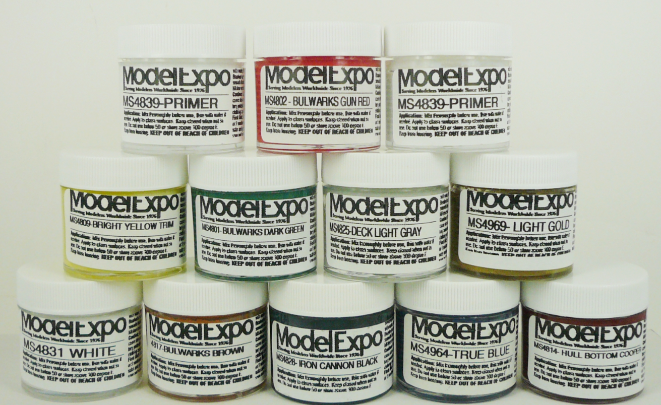 A set of 12 1oz bottles of Model Expo acrylic paint and stain in various colors, including white, gold, and dark green, labeled for different parts such as 'Bulwarks Brown' and 'Cannon Black'.