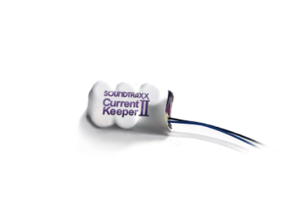 The image shows the SoundTraxx CurrentKeeperII, which is a small, white rectangular device with the brand name and product title printed on it.