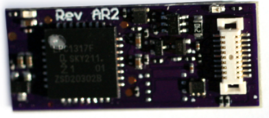 A purple SoundTraxx TSU-N18 Steam-2 model train decoder with digital and analog components visible.