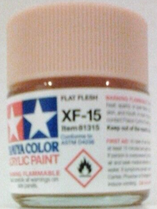 A 23ml bottle of Tamiya XF-15 Flat Flesh Acrylic Paint with label and safety warning.