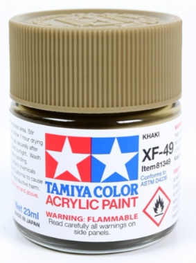 A 23ml jar of Tamiya brand XF-49 khaki acrylic paint with a label showing the color and brand name, with warning signs for flammability.