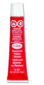 A red and white tube of Testors plastic cement for model making.