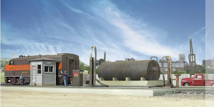 Model of a diesel fueling facility kit including a storage tank, fuel crane, pump house, and track pans set against a blue sky backdrop.