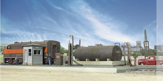 Model of a diesel fueling facility kit including a storage tank, fuel crane, pump house, and track pans set against a blue sky backdrop.