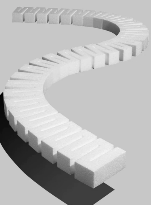 A set of white model train risers, arranged in a curve, designed to create varying grades on a model train layout.