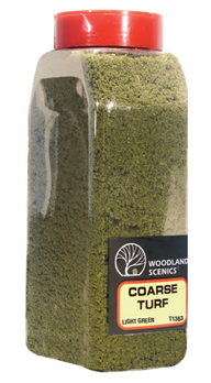 A shaker bottle filled with light green coarse turf, labeled Woodland Scenics Coarse Turf, with a red cap on top.