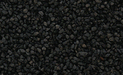 A close-up view of medium ballast shaker cinders, predominantly black in color, used for model train purposes.