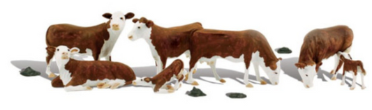 A set of model figures depicting two calves and five adult Hereford cows in various poses, designed for HO scale model train layouts.