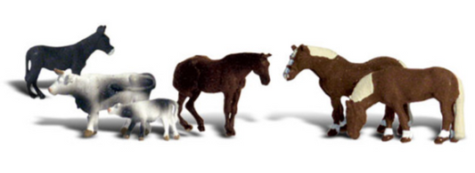 A set of model animals including a donkey, cow, calf, black horse, and two workhorses designed for a model train set.