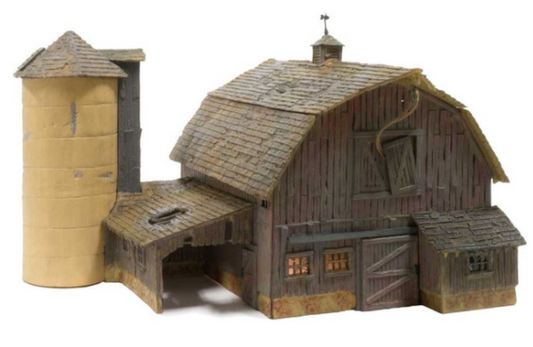 An old weathered barn model with a silo, featuring a shake shingle roof, hayloft door with pulley and rope, and various detailed parts like windows and doors, intended for N Scale model railroading.