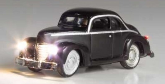 Black N scale model of a 1940s to 1950s coupe with LED headlights and taillights, designed for use in model train sets.