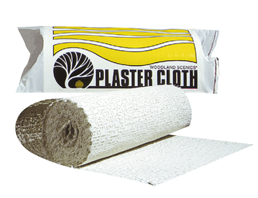 A roll of plaster cloth next to its packaging, which has the brand name 'Woodland Scenics' on it.