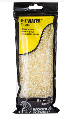 A package of Woodland Scenics C1206 E-Z Water in the form of yellow pellets, designed for model train use.