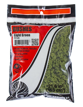 Packaging of Woodland Scenics FC145 Light Green Bushes, showing the product in a clear plastic bag with red and white branding, and a label with the product details.