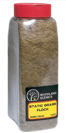 A container of Woodland Scenics FL633 Static Grass Flock in a burnt grass color, designed for model train scenery.