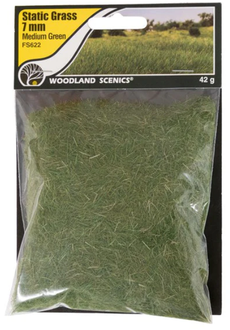 A pack of Woodland Scenics FS622 Static Grass in medium green color, designed for model train use.