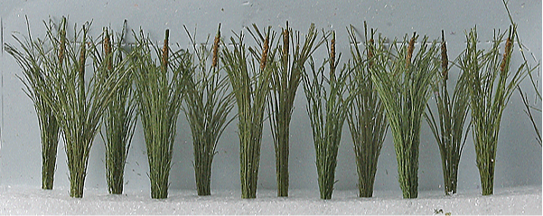 A set of green miniature cat tails meant for use in model train setups, displayed against a neutral background.