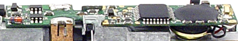 A green printed circuit board for a model train sound decoder, featuring various electronic components and branding.